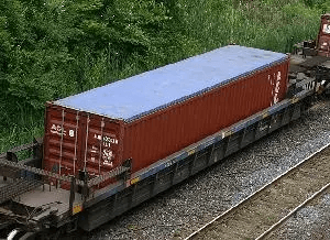 Open top shipping container on train